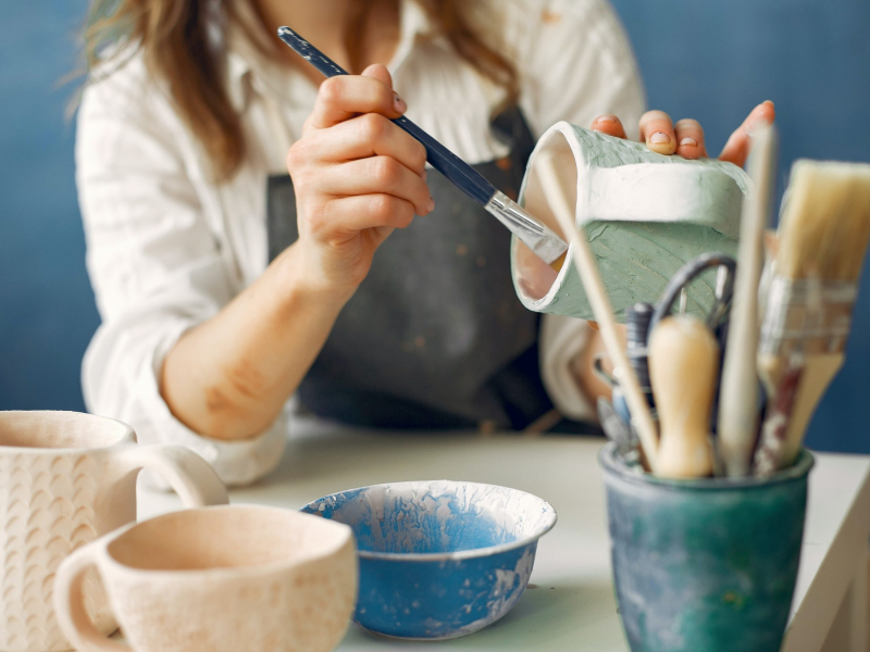 creative-female-artisan-painting-clay-product-4241334